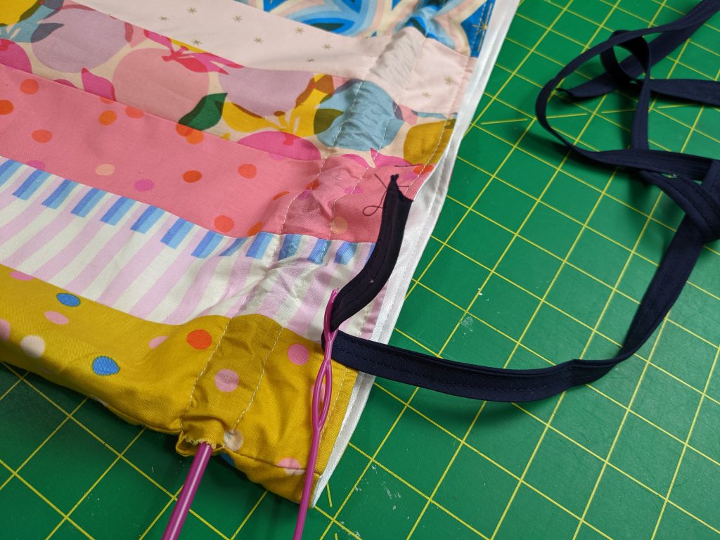 Cut the ribbon for the right length to match your drawstring bag
